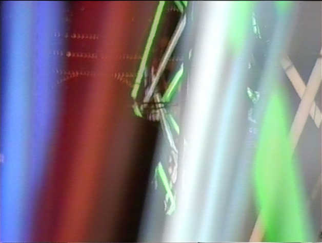 Video still of multi-coloured fluorescent lights in motion. 