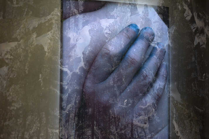 film still of a hand with a double exposure of a snow landscape in the backgroup