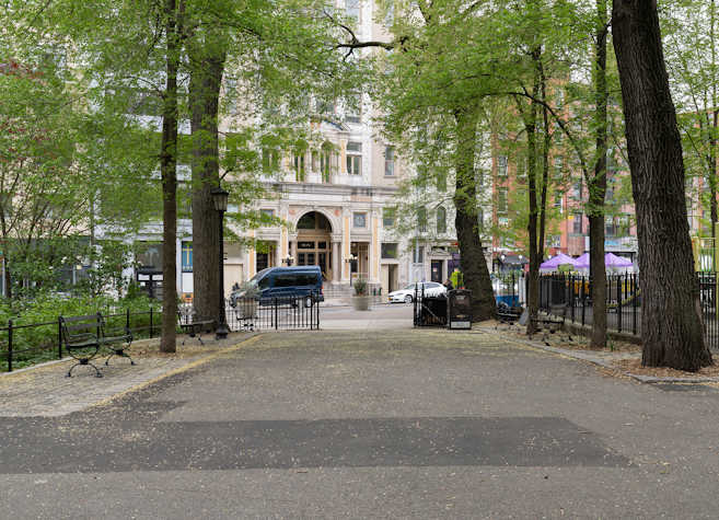 On either side of a path inside Seaward Park are six-foot benches that were added to the park without permission. There are three benches on one side of the path and two on the other side.