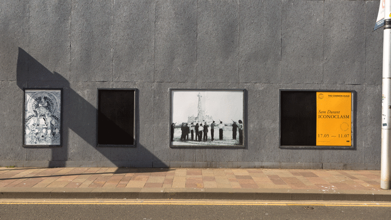 a series of public poster sites display intricate line drawings of statues being toppled
