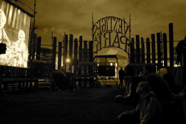 yellow filtered image of an outdoor scene with a fence reading 'vestiges park'