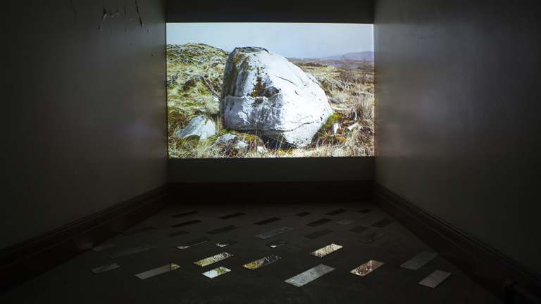 gallery installation, film screen showing landscape images