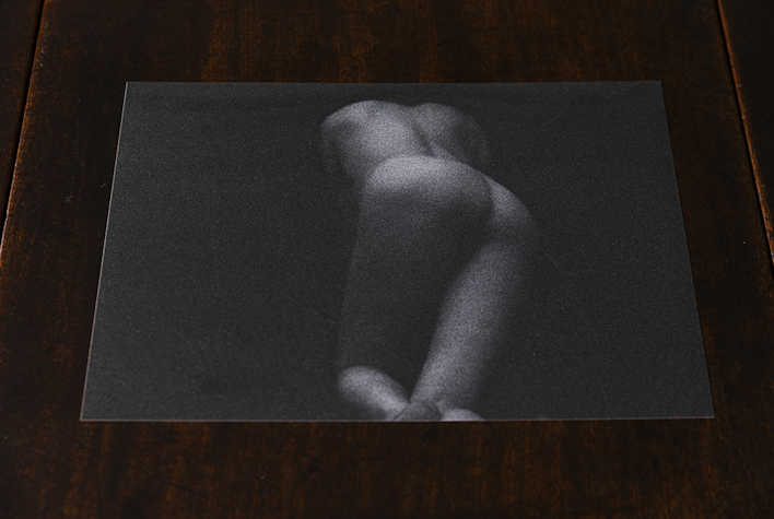 A black and white artwork of a nude.