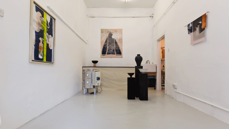 Paintings and ceramics in a small room