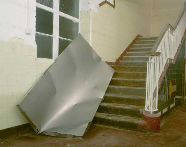 large sheet of metal leaning on a staircase