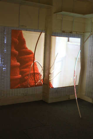 projection of a close up of someones arm in a red jumper