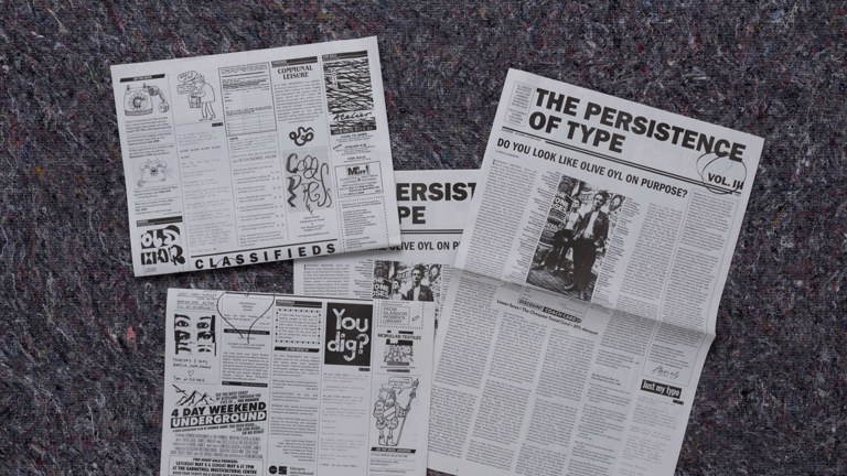 Four newspapers displayed on the ground of The Persistence of Type Volume III
