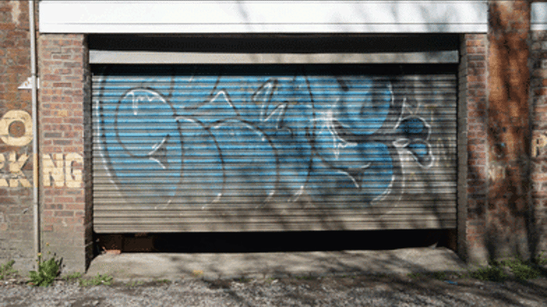 roller-shutter garage door behind Glasgow's Mitchell library with spray painted graffiti