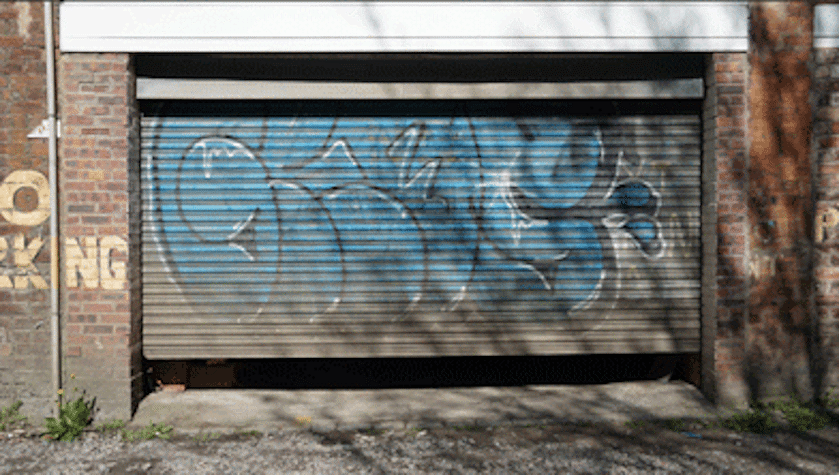 roller-shutter garage door behind Glasgow's Mitchell library with spray painted graffiti