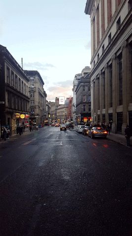 City scene with advertising screen in the distance