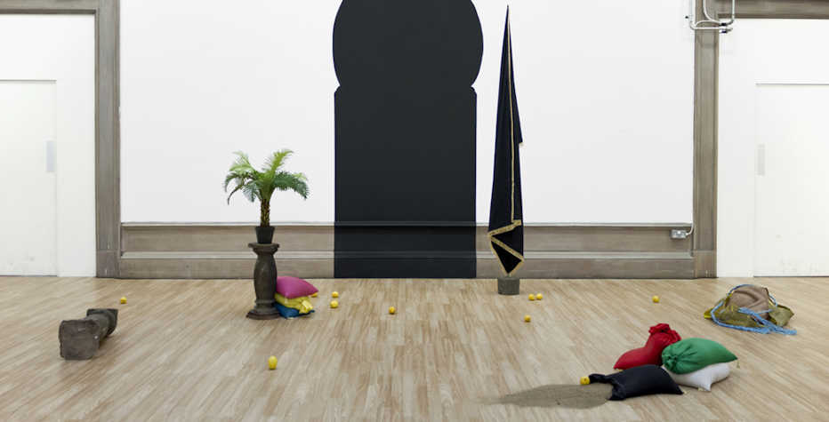Sculptural objects in a gallery with white walls and a wooden floor