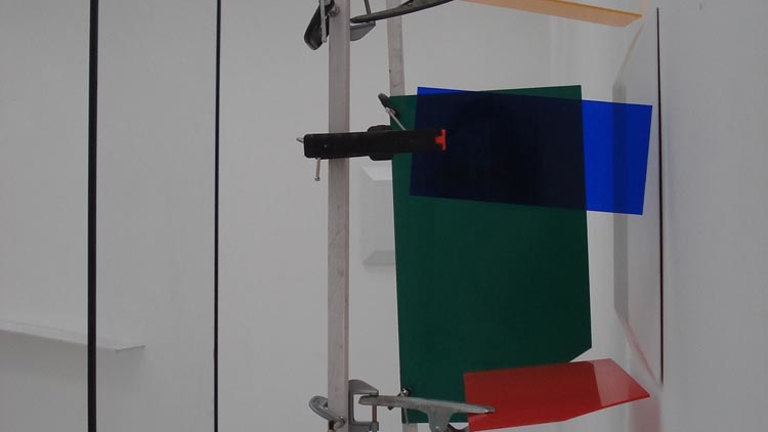 studio installation by ben walker. clamps holding up pieces of coloured perspex.