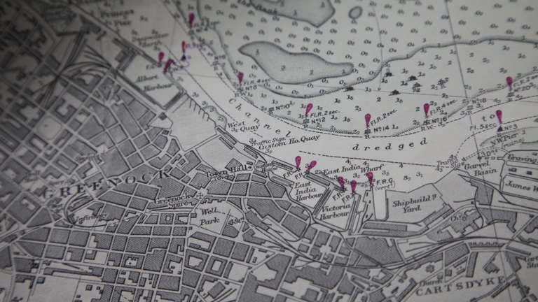 Close-up of a historical navigational map of the River Clyde showing dredged channels, harbour areas, depth marking, and dock infrastructure. Pink handwritten annotations highlight specific sites along the river.