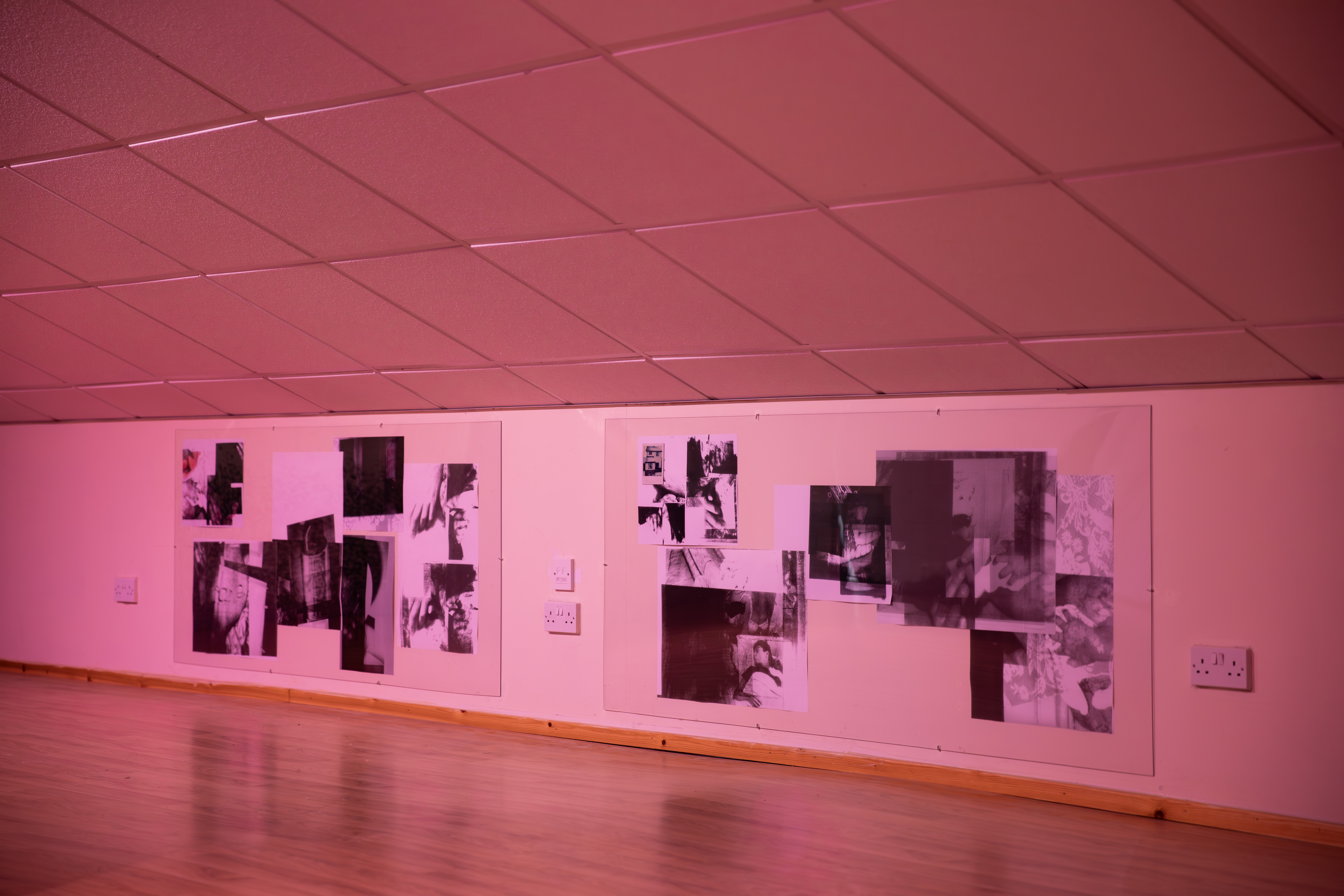 Two black and white photographic collages, each made up of overlapping fragmented images, mounted on a pink-lit wall at Gulabi Gallery.