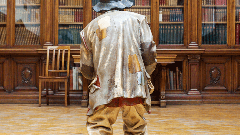 Sculptural figure viewed from behind within The Jeffrey Library