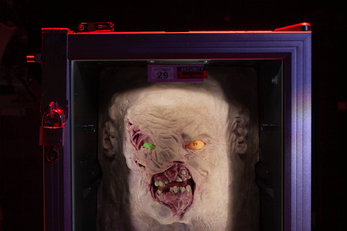 A grotesque half-rat half-human face is in a fridge