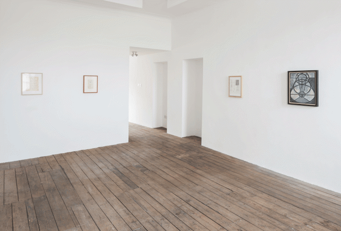 Installation view of exhibition, with abstract art work visible on the walls
