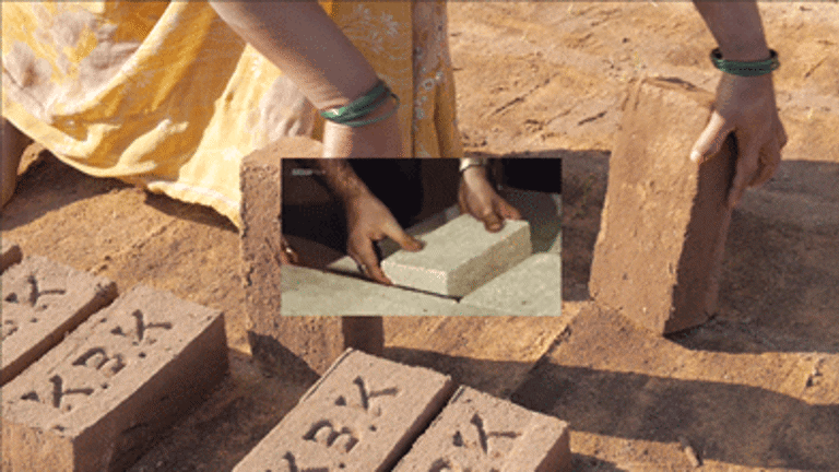 film still, hands laying bricks