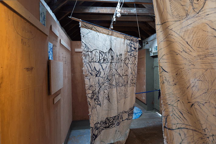 batik fabric hangings on calico are suspended
