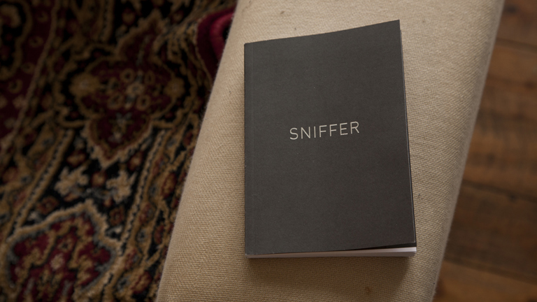 Book titled Sniffer lying on patterned rug