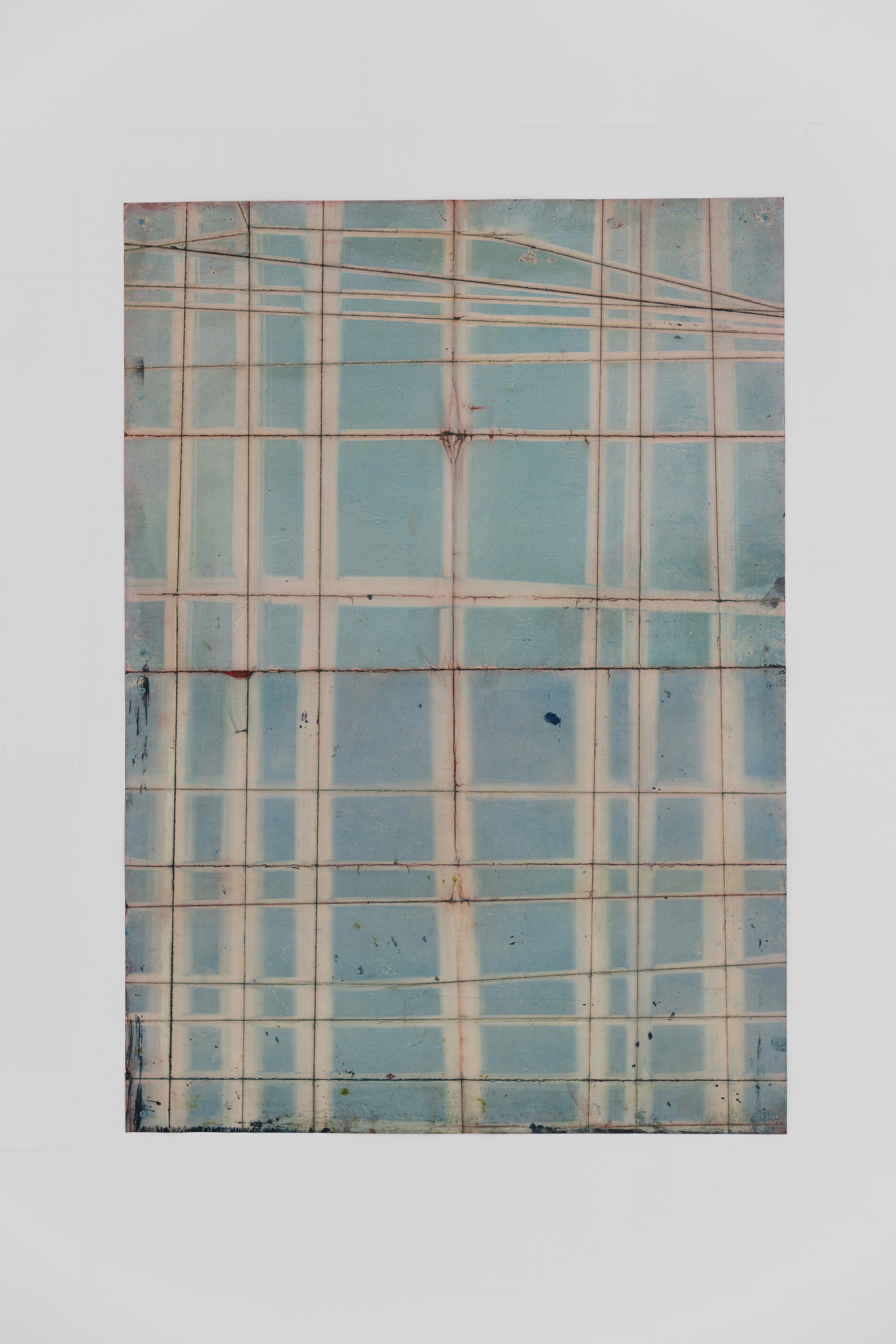 Anna Paterson's "Oriel," a large panel work in oil on paper with screws, its surface divided into a pale blue grid crossed with faint diagonal lines.