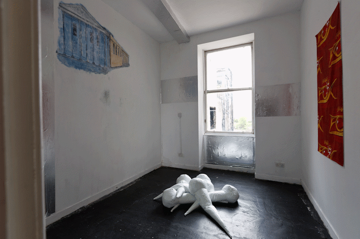 abstract white pvc sculpture on black floor of room
