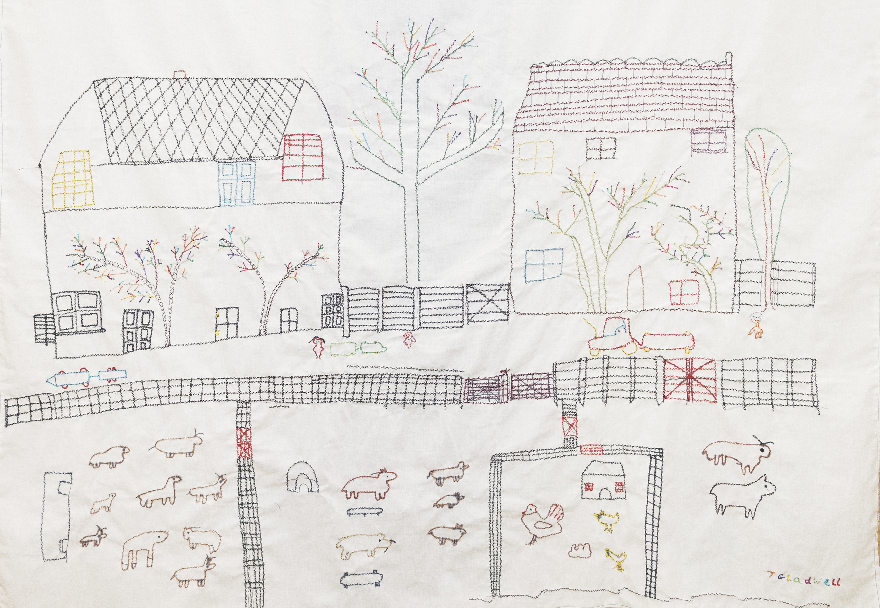 Cross-Stitch artwork on pale calico depicting a farm scene. Sheep and other animals appear along the bottom with fences and chickens. Behind the fences stand two large buildings and a large tree in the centre, rendered in multicoloured stitching.