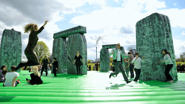 inflatable structure resembling stonehenge with people jumping on it