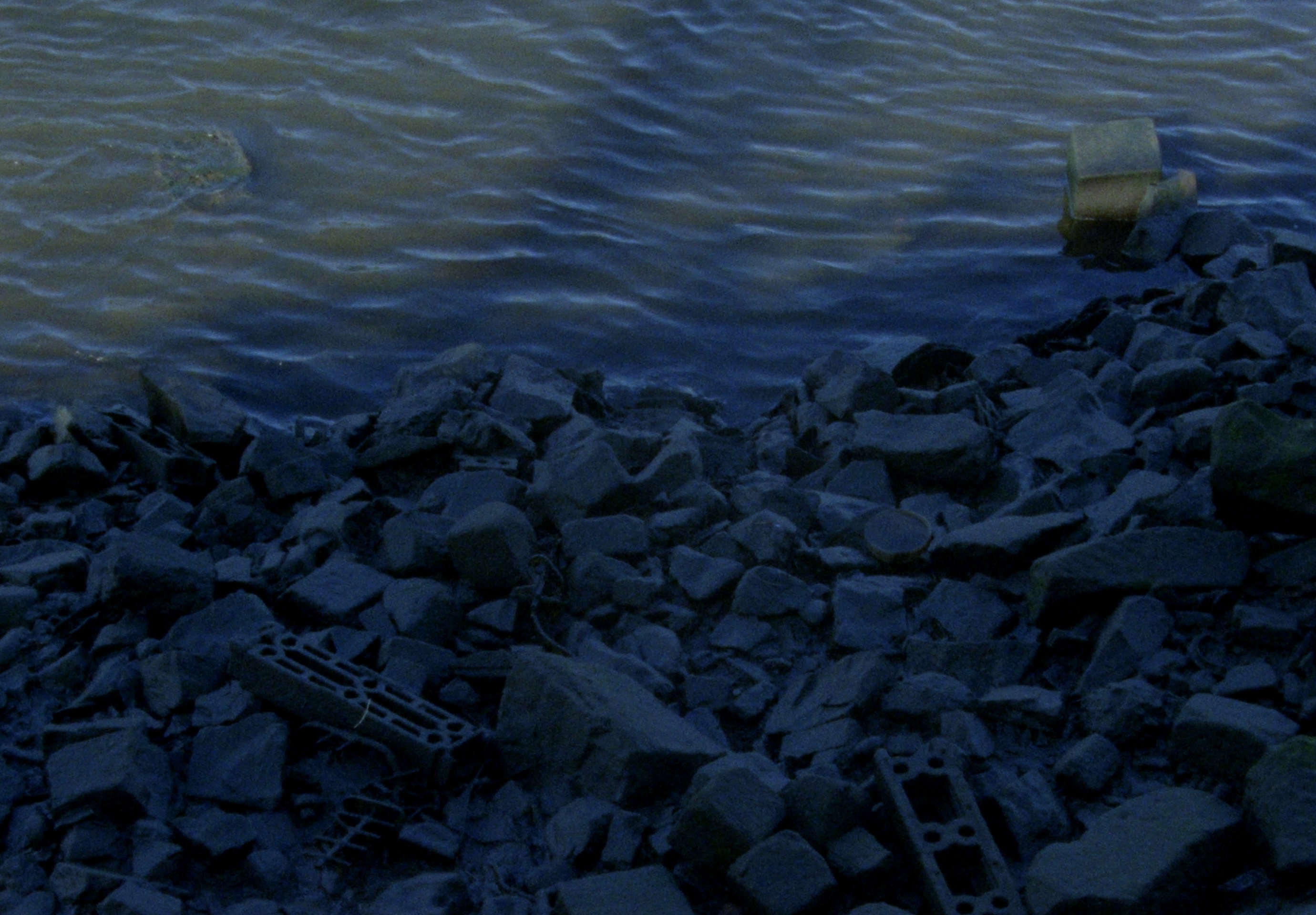An image of rocks and water by the shore