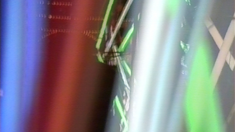 Video still of multi-coloured fluorescent lights in motion. 