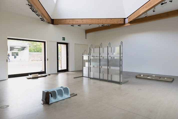 a series of abstract floor-based sculptures in a gallery
