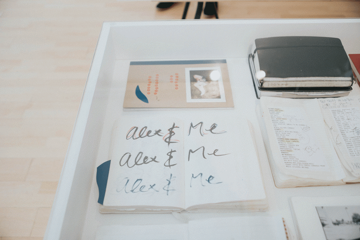 Close up photograph of material in a vitrine showing notebooks and hand-written notes