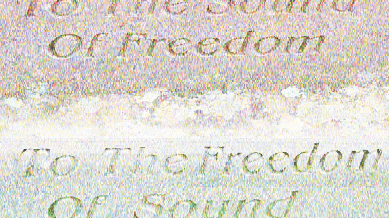 A grainy image that shows the text "To The Sound of Freedom" at the bottom and top of the image. 
