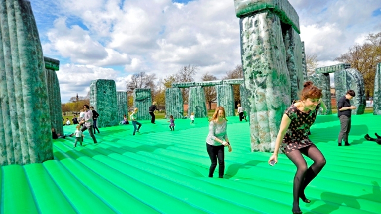 people jumping on a bouncy castle version of Stonehenge