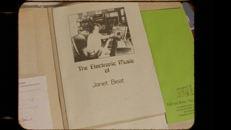 A detailed photography of an open book. The text reads "The Electronic Music of Janet Beat." 