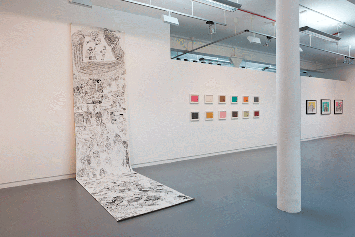 drawings hang on a gallery wall