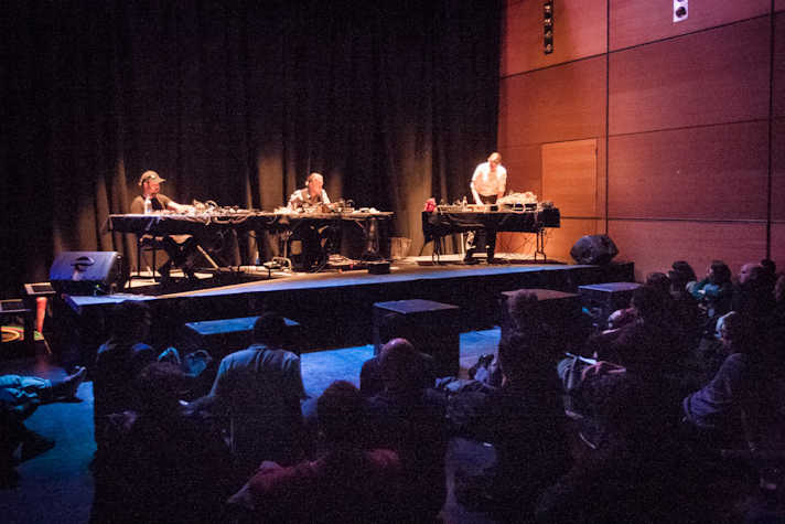 Counterflows : CCA musicians behind mixing desks on a stage in front of an audience