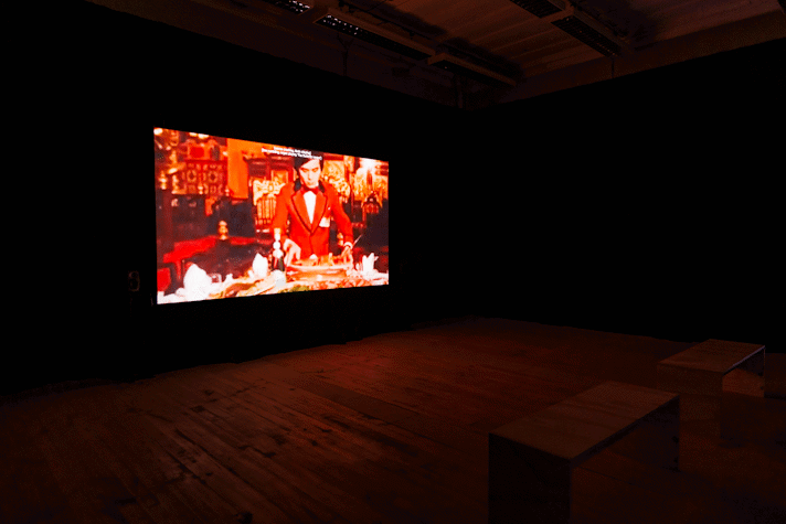 Film is projected onto a screen in a dark room.