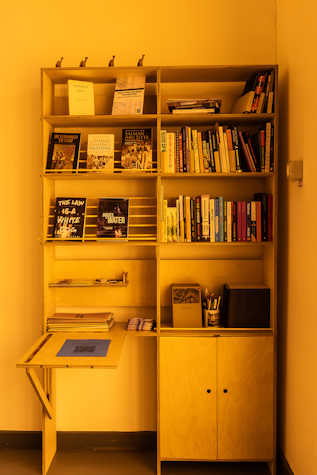 A close up of a bookshelf with books displayed.