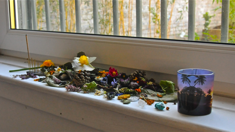 Dried flowers on windowsill with a glass jar