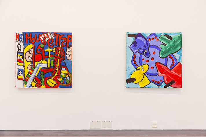 Two colourful square artworks are displayed side by side against a white wall.