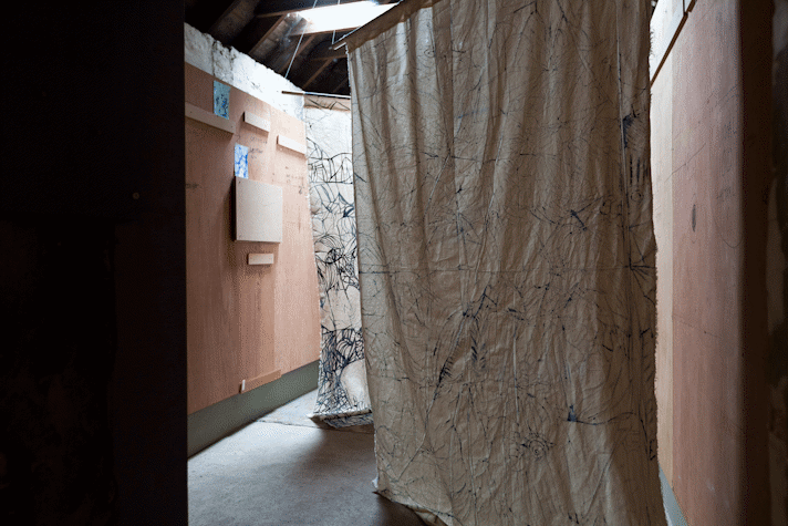batik fabric hangings on calico are suspended