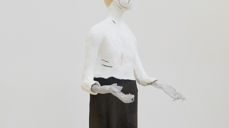 An image of a single sculpted figure by Cathy Wilkes in a gallery 